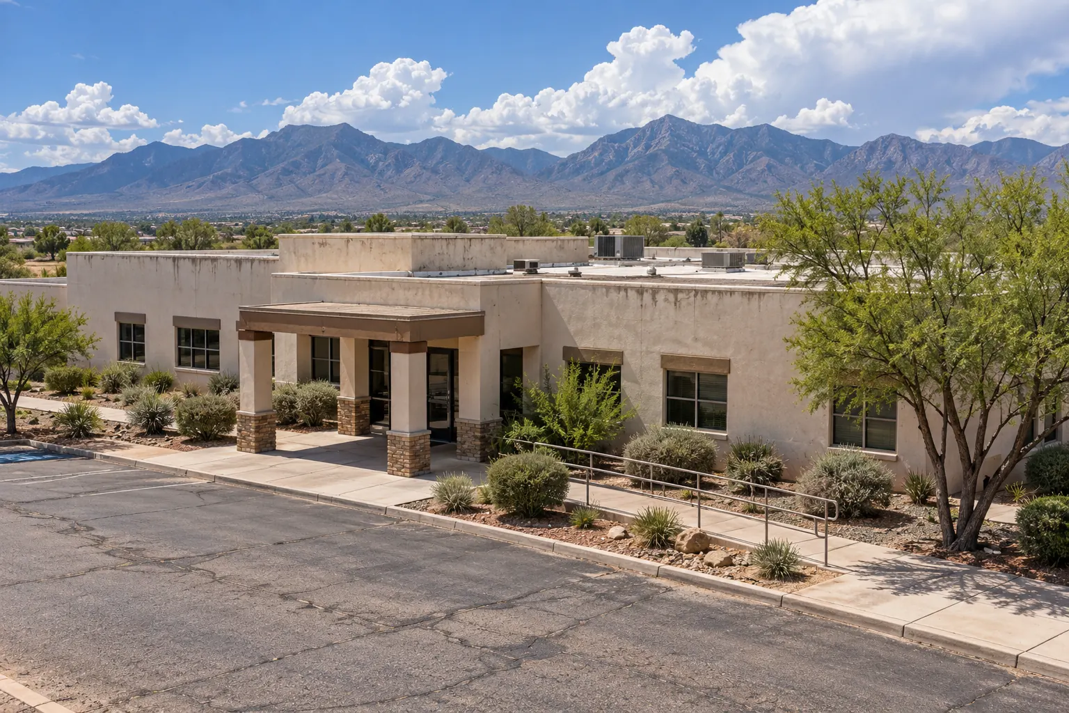 Single-story commercial building with parapets and rooftop units seen from a slight elevation